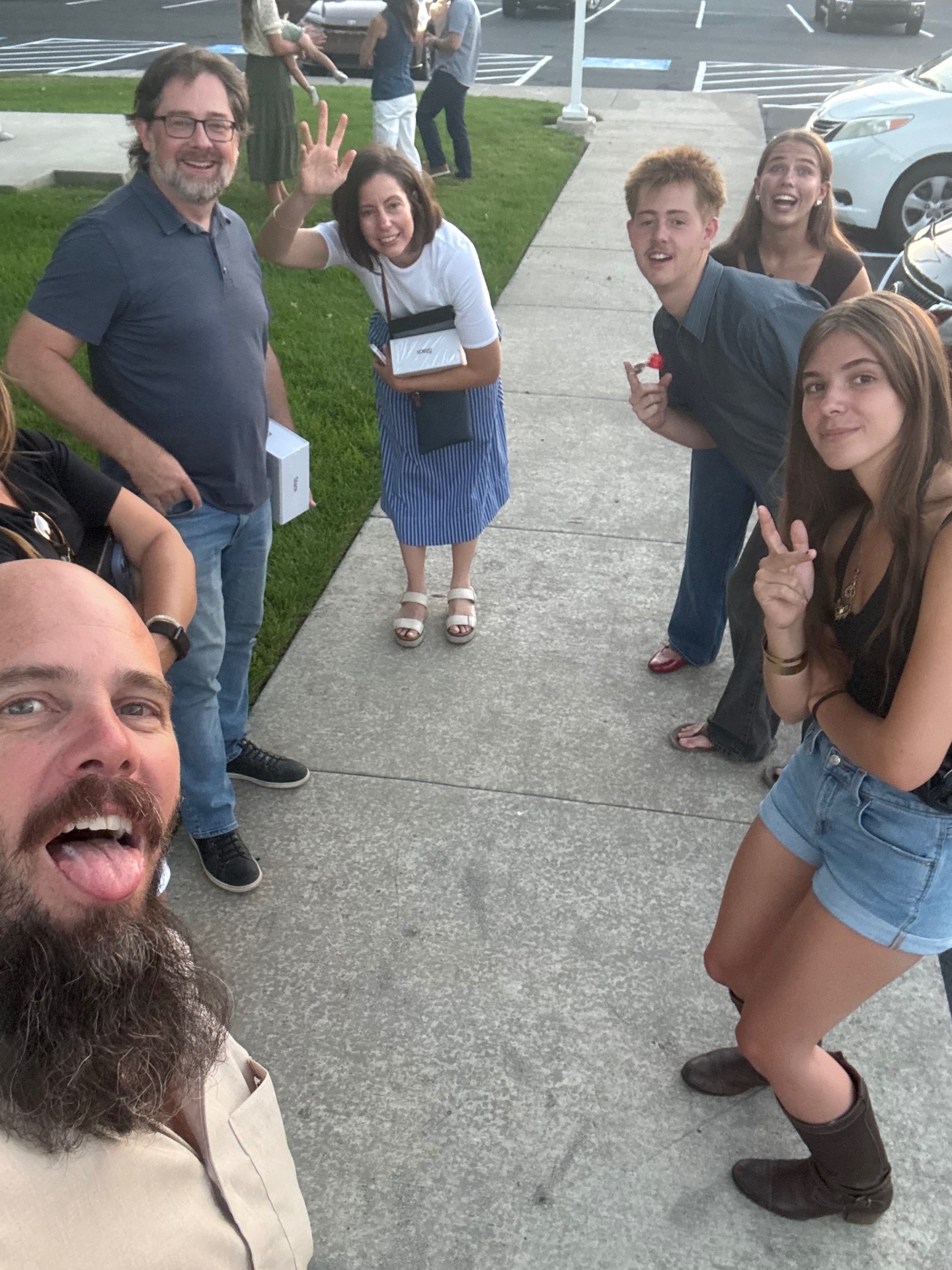 Cousins hanging out and waving in the parking lot after dinner