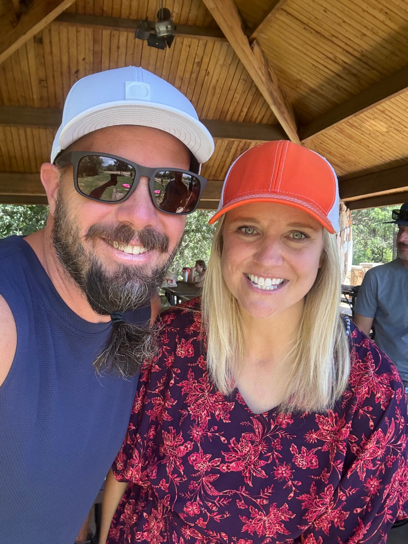 A couple smiling under the pavilion at Highland Glen